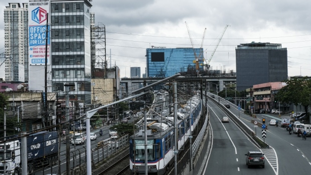The Metro Rail Transit train travels along a track in Makati City, Metro Manila, the Philippines, on Monday, Aug. 15, 2022. Bangko Sentral ng Pilipinas delivered an off-cycle rate increase of 75 basis points last month to tame inflation that’s almost at a four-year high and prop up the weakening peso.